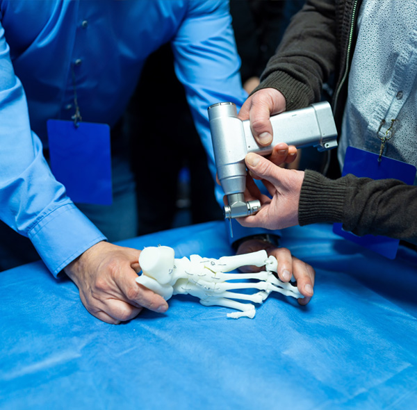 Participants engage in hands-on learning with a robotic device and a prosthetic hand, enhancing skills in medical tech